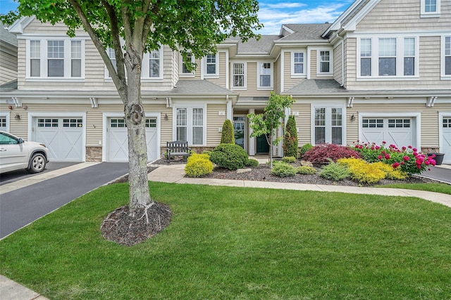 23 Sonata Ct, Lake Grove, NY 11755 - view of property with an attached garage, driveway, a front lawn, and roof with shingles