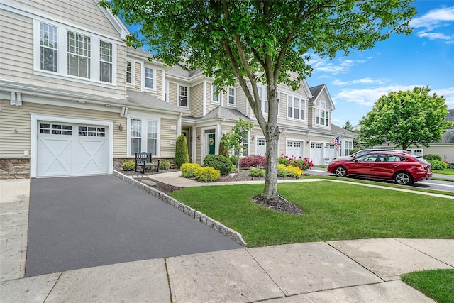 23 Sonata Ct, Lake Grove, NY 11755 - multi unit property featuring a garage, a front yard, stone siding, driveway, and a residential view