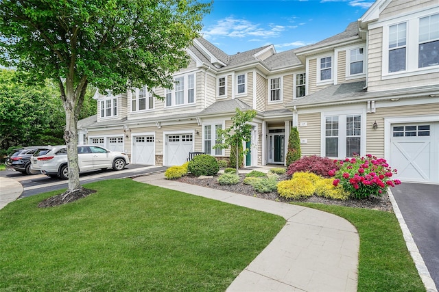 23 Sonata Ct, Lake Grove, NY 11755 - multi unit property featuring driveway, a front yard, an attached garage, and roof with shingles