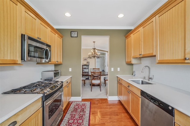23 Sonata Ct, Lake Grove, NY 11755 - kitchen featuring appliances with stainless steel finishes, a sink, ornamental molding, light brown cabinetry, and light countertops