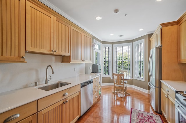 23 Sonata Ct, Lake Grove, NY 11755 - kitchen with stainless steel appliances, a sink, baseboards, light countertops, and light wood-style flooring