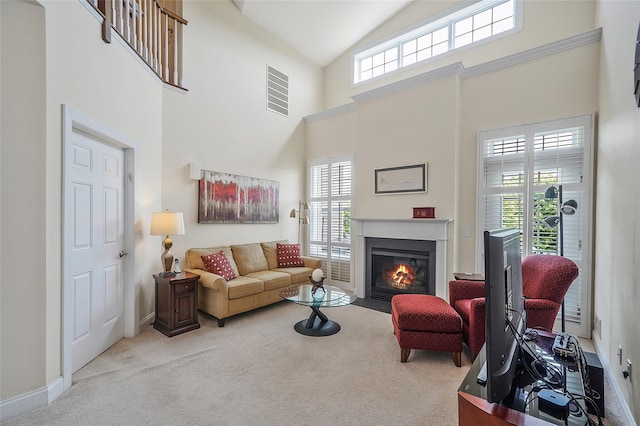 23 Sonata Ct, Lake Grove, NY 11755 - carpeted living area with healthy amount of natural light, high vaulted ceiling, a fireplace with flush hearth, and baseboards
