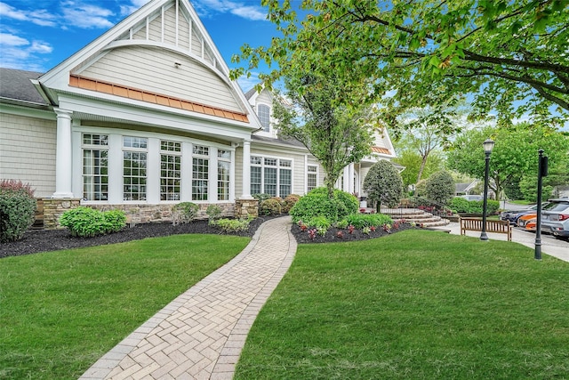 23 Sonata Ct, Lake Grove, NY 11755 - back of property with a yard, stone siding, and a standing seam roof