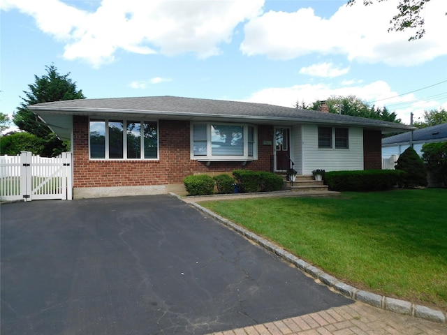 7 Audrey Ln, Commack, NY 11725 - ranch-style home featuring brick siding, a gate, a chimney, and driveway