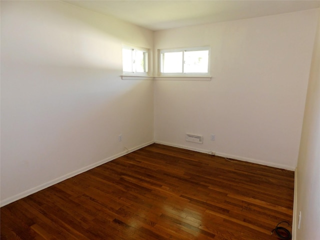 7 Audrey Ln, Commack, NY 11725 - empty room featuring dark wood-style floors and baseboards
