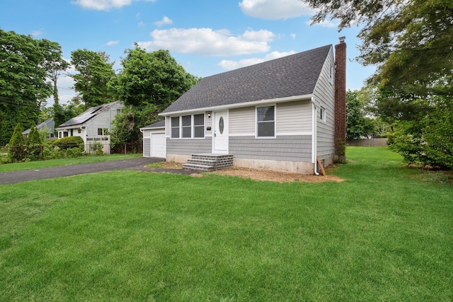 17 21 St Ave, Bay Shore, NY 11706 - view of front of house with a chimney, a shingled roof, and a garage