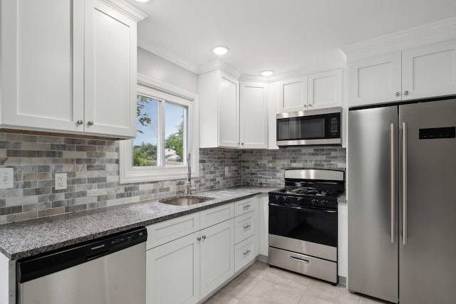 17 21 St Ave, Bay Shore, NY 11706 - kitchen with appliances with stainless steel finishes, a sink, ornamental molding, white cabinets, and dark stone counters