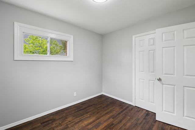 17 21 St Ave, Bay Shore, NY 11706 - unfurnished bedroom with baseboards and dark wood-style flooring