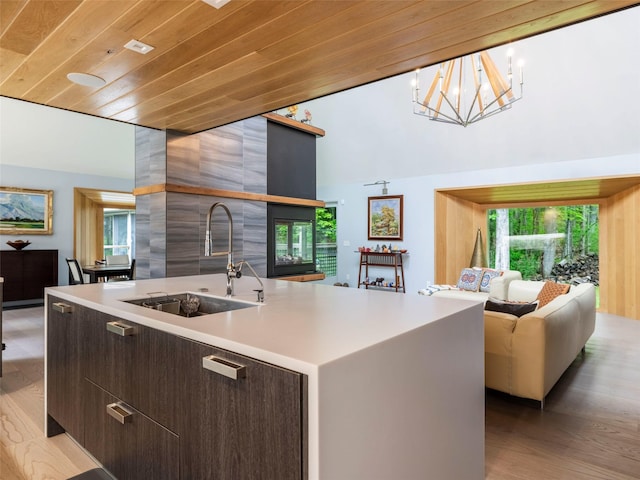 16 Juniper Ln, Woodstock, NY 12498 - kitchen with a sink, modern cabinets, light wood-style floors, light countertops, and a center island with sink