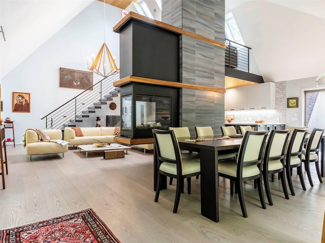 16 Juniper Ln, Woodstock, NY 12498 - dining area featuring high vaulted ceiling, light wood-style floors, and stairs
