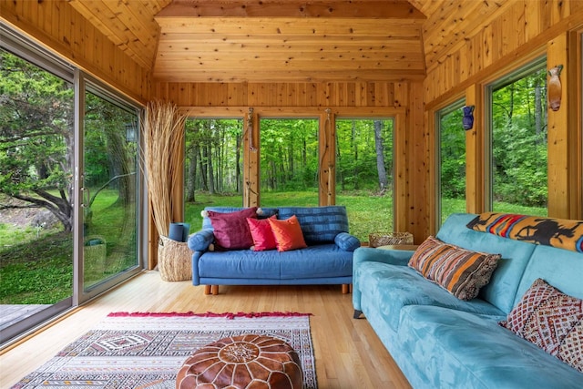 16 Juniper Ln, Woodstock, NY 12498 - sunroom with an outdoor hangout area, vaulted ceiling, plenty of natural light, hardwood / wood-style flooring, and wood walls