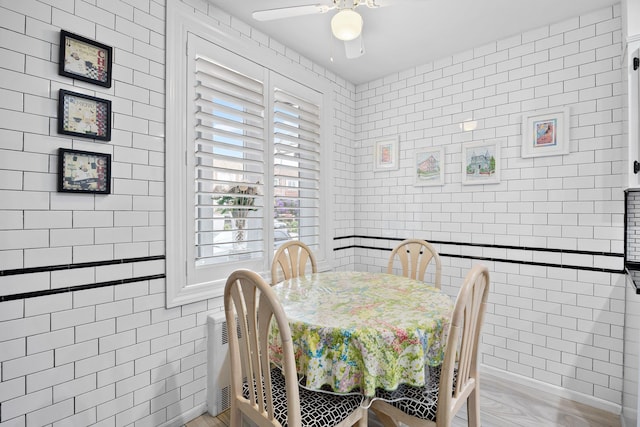 64-30 73rd Pl, Middle Village, NY 11379 - dining area with tile walls and ceiling fan