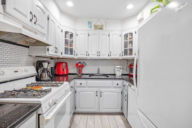 64-30 73rd Pl, Middle Village, NY 11379 - kitchen with white appliances, under cabinet range hood, a sink, white cabinets, and recessed lighting
