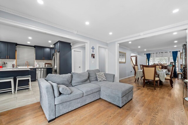 14-50 141st St, Whitestone, NY 11357 - living room featuring ornamental molding, recessed lighting, light wood-style floors, and baseboards
