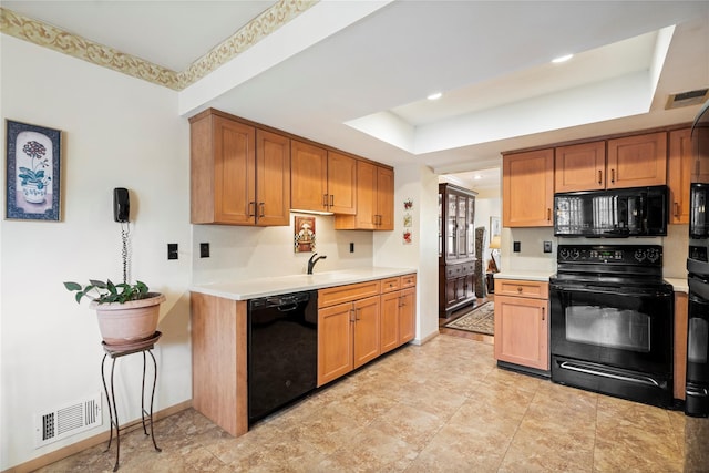 38 The Mews, Syosset, NY 11791 - kitchen featuring black appliances, a tray ceiling, light countertops, baseboards, and a sink