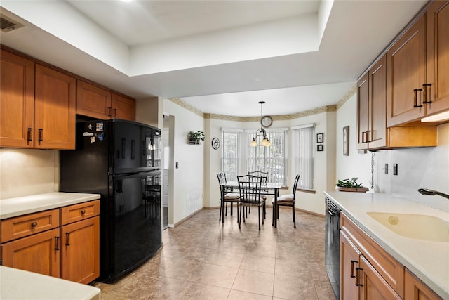 38 The Mews, Syosset, NY 11791 - kitchen featuring black appliances, a sink, brown cabinets, light countertops, and backsplash