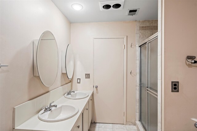 38 The Mews, Syosset, NY 11791 - bathroom with double vanity, a stall shower, and tile patterned flooring