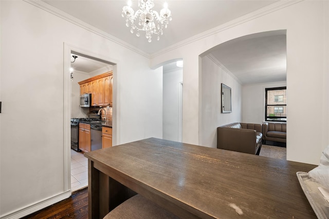 7607 Ditmars Blvd Unit 1, East Elmhurst, NY 11370 - dining space with arched walkways, crown molding, a chandelier, and dark wood-style flooring