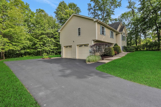 390 Lakeside Rd, Newburgh, NY 12550 - view of home's exterior with driveway, a garage, and a lawn