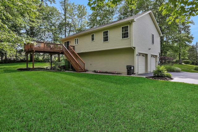 390 Lakeside Rd, Newburgh, NY 12550 - back of house with stairway, an attached garage, a wooden deck, a lawn, and driveway