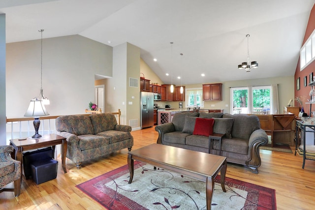 390 Lakeside Rd, Newburgh, NY 12550 - living area with a chandelier, high vaulted ceiling, light wood finished floors, and recessed lighting