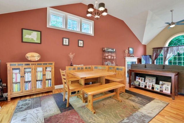 390 Lakeside Rd, Newburgh, NY 12550 - dining area with wood finished floors, high vaulted ceiling, a ceiling fan, and a chandelier
