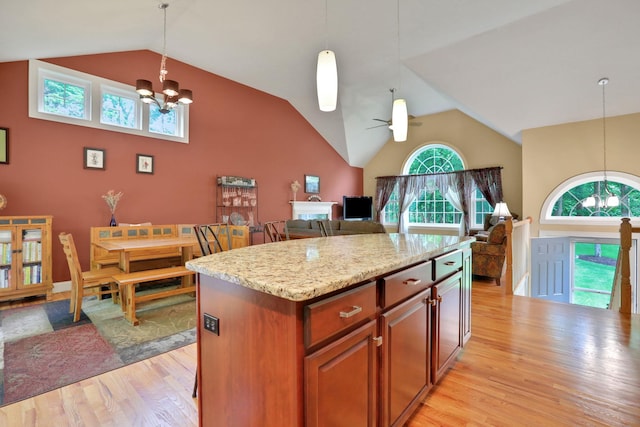390 Lakeside Rd, Newburgh, NY 12550 - kitchen with light wood finished floors, pendant lighting, a chandelier, and high vaulted ceiling