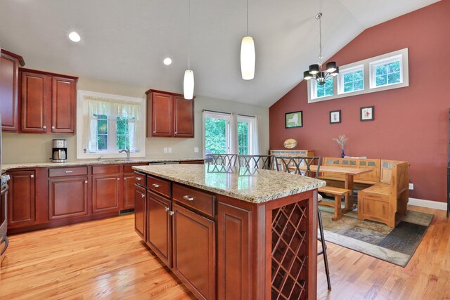 390 Lakeside Rd, Newburgh, NY 12550 - kitchen with a kitchen island, light wood finished floors, plenty of natural light, decorative light fixtures, and high vaulted ceiling
