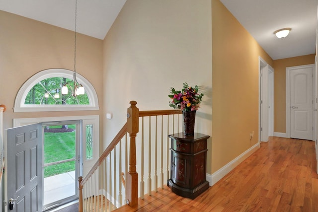 390 Lakeside Rd, Newburgh, NY 12550 - foyer entrance with wood finished floors, high vaulted ceiling, a chandelier, and baseboards