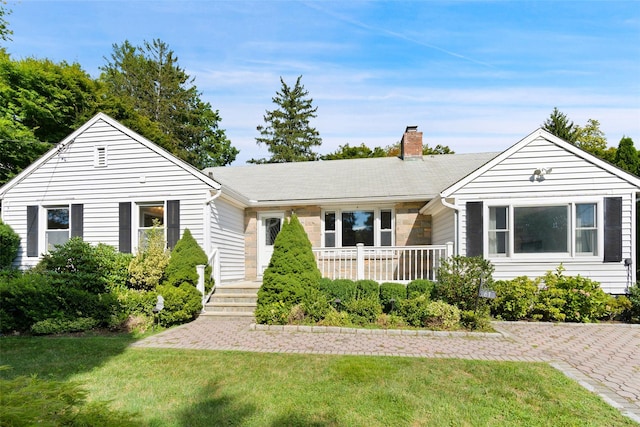 61 Tamarack Rd, Rye Brook, NY 10573 - ranch-style house featuring a chimney and a front lawn