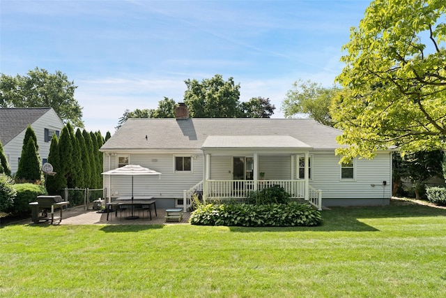61 Tamarack Rd, Rye Brook, NY 10573 - back of property featuring a lawn, a chimney, a porch, and a patio