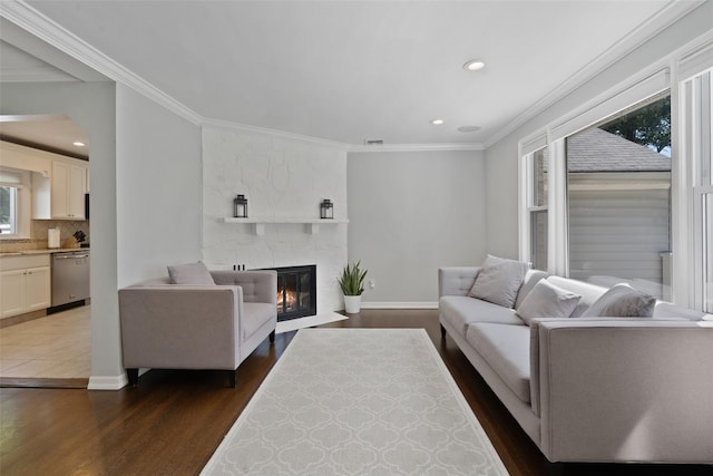 61 Tamarack Rd, Rye Brook, NY 10573 - living room featuring ornamental molding, dark wood-type flooring, recessed lighting, a stone fireplace, and baseboards