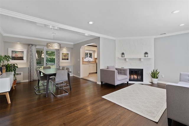61 Tamarack Rd, Rye Brook, NY 10573 - dining room featuring radiator heating unit, dark wood-type flooring, arched walkways, baseboards, and recessed lighting