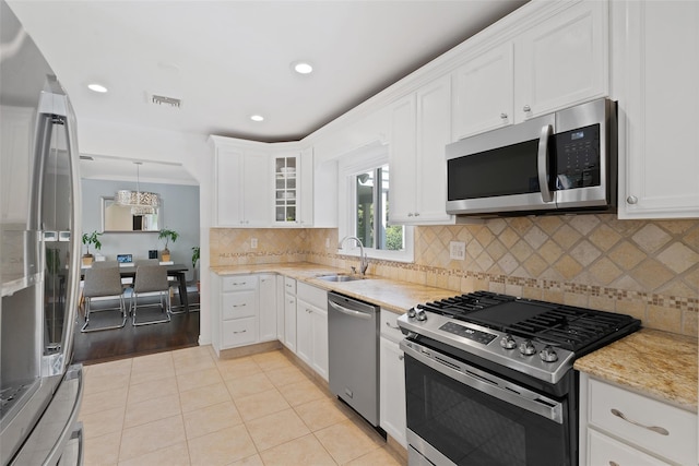 61 Tamarack Rd, Rye Brook, NY 10573 - kitchen with appliances with stainless steel finishes, a sink, white cabinets, tasteful backsplash, and glass insert cabinets