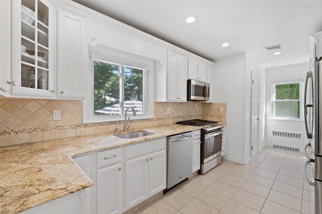 61 Tamarack Rd, Rye Brook, NY 10573 - kitchen with stainless steel appliances, radiator heating unit, a sink, plenty of natural light, and recessed lighting