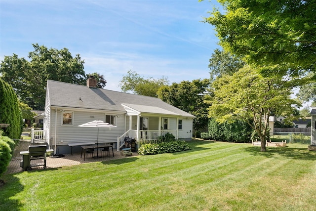 61 Tamarack Rd, Rye Brook, NY 10573 - rear view of property with a chimney and a patio
