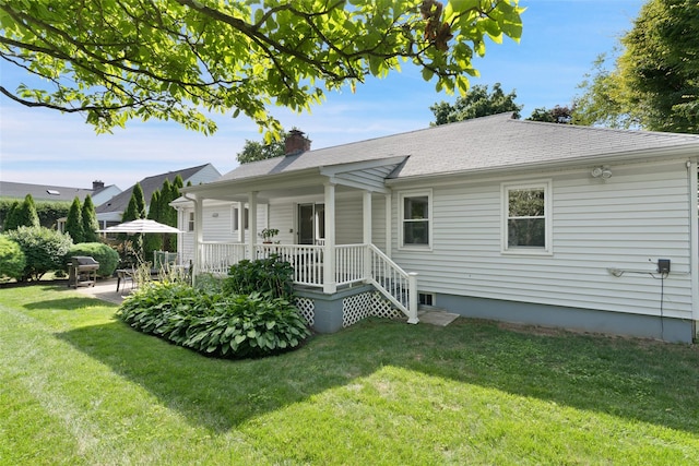 61 Tamarack Rd, Rye Brook, NY 10573 - view of front of home with a front lawn, a chimney, and a porch