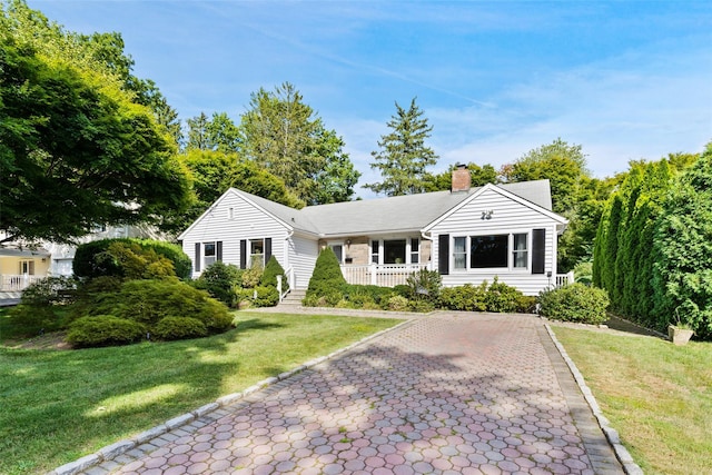61 Tamarack Rd, Rye Brook, NY 10573 - ranch-style home with a chimney and a front yard