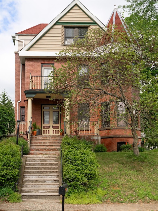 511 Grand Ave, Newburgh, NY 12550 - view of front of house with brick siding, a balcony, and covered porch