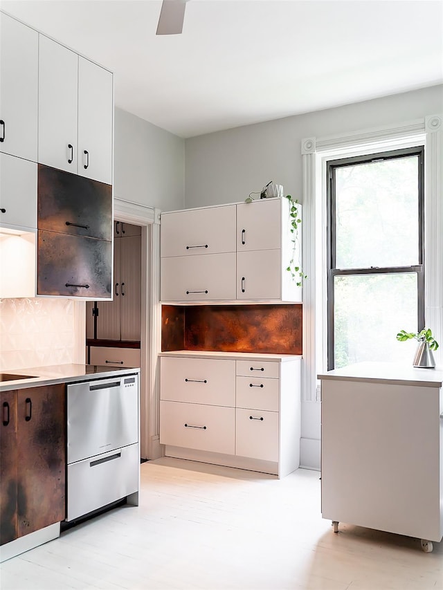 511 Grand Ave, Newburgh, NY 12550 - kitchen with white cabinets, tasteful backsplash, stainless steel dishwasher, and light countertops