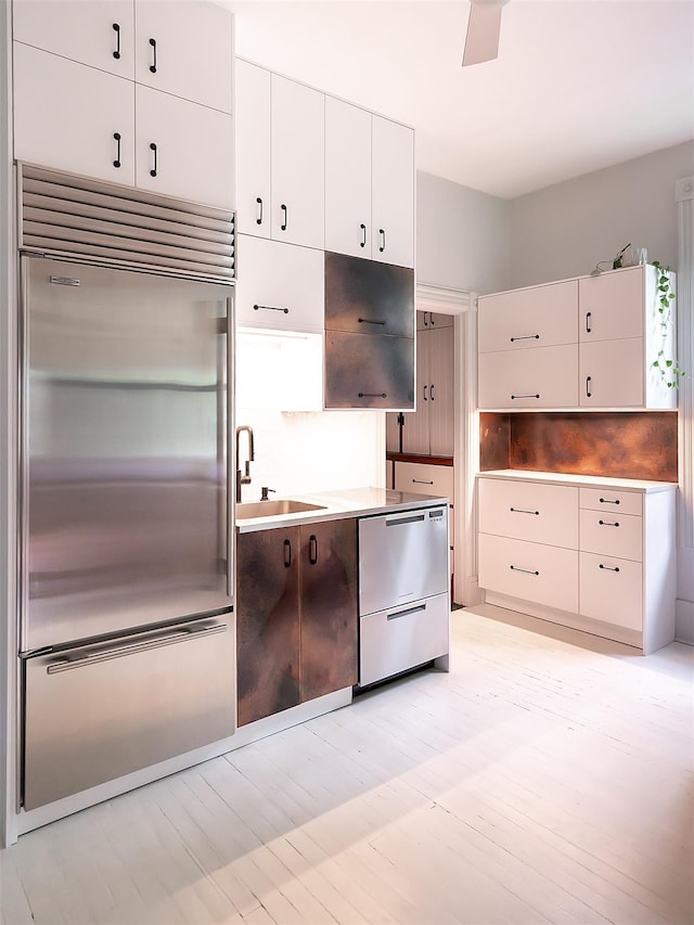 511 Grand Ave, Newburgh, NY 12550 - kitchen with stainless steel appliances, a sink, stainless steel counters, white cabinets, and backsplash