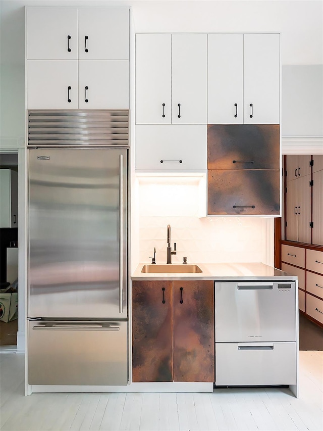 511 Grand Ave, Newburgh, NY 12550 - kitchen featuring appliances with stainless steel finishes, a sink, white cabinets, and light countertops