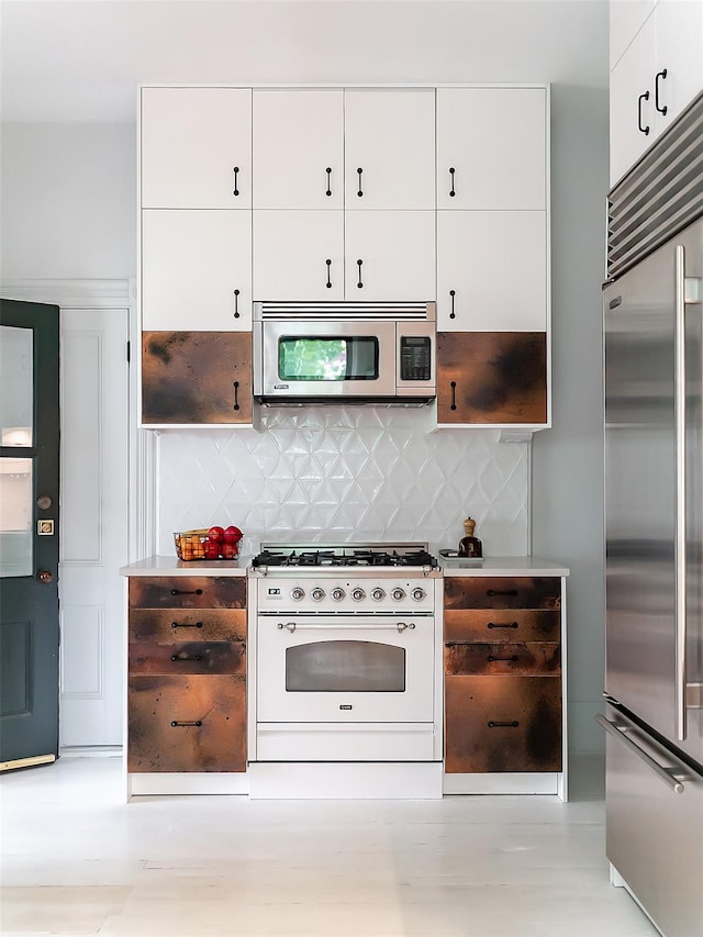 511 Grand Ave, Newburgh, NY 12550 - kitchen featuring stainless steel appliances, white cabinetry, backsplash, and light countertops
