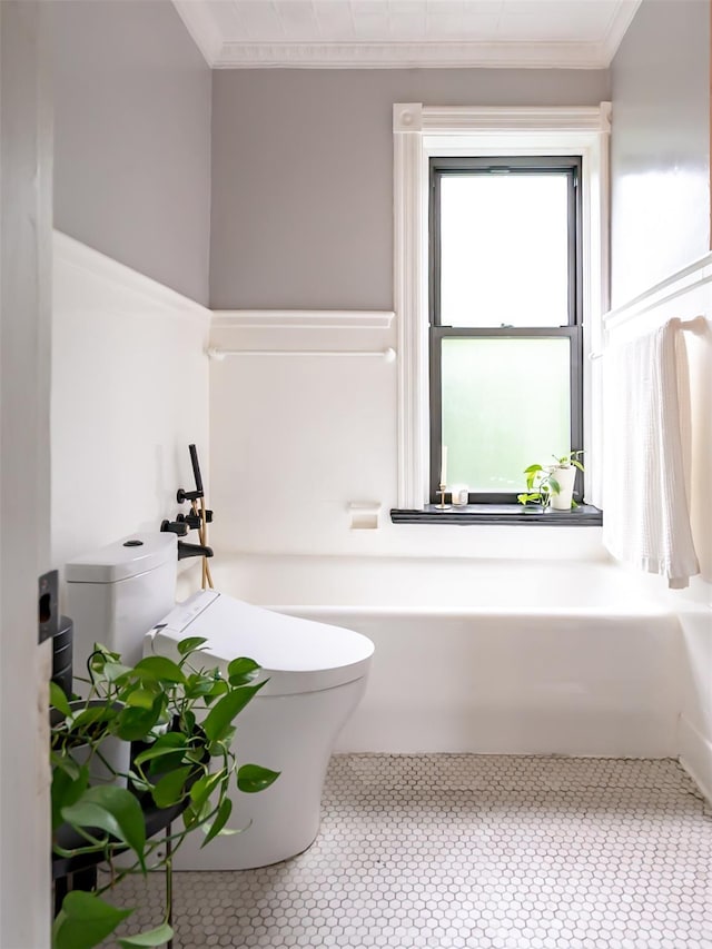 511 Grand Ave, Newburgh, NY 12550 - bathroom featuring toilet, ornamental molding, and a tub to relax in