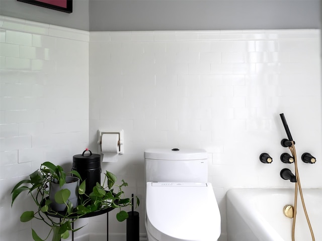 511 Grand Ave, Newburgh, NY 12550 - full bathroom with toilet, a bath, and tile walls