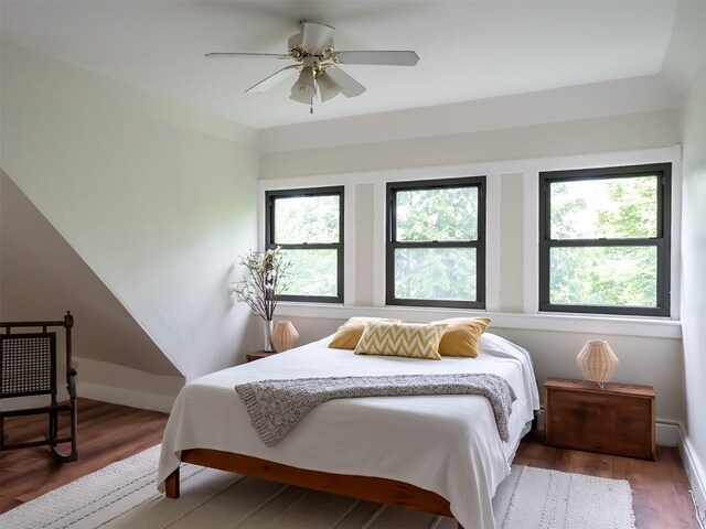511 Grand Ave, Newburgh, NY 12550 - bedroom featuring multiple windows, wood finished floors, and baseboards