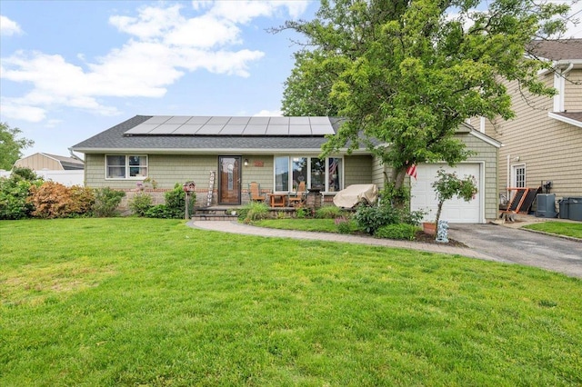 3363 Emeric Ave, Wantagh, NY 11793 - ranch-style home featuring solar panels, asphalt driveway, a front lawn, and an attached garage