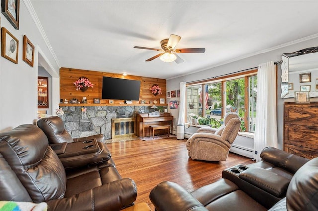 3363 Emeric Ave, Wantagh, NY 11793 - living area with ornamental molding, a ceiling fan, wood finished floors, baseboard heating, and wooden walls