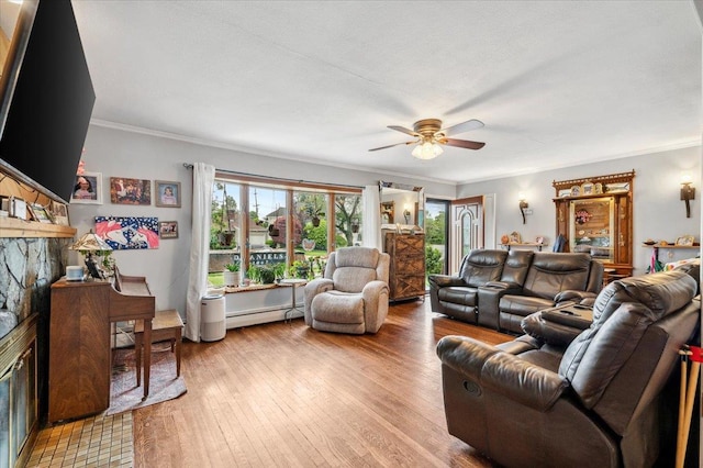 3363 Emeric Ave, Wantagh, NY 11793 - living area with a baseboard heating unit, a ceiling fan, a fireplace, ornamental molding, and light wood-type flooring