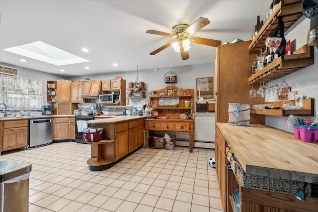 3363 Emeric Ave, Wantagh, NY 11793 - kitchen with open shelves, appliances with stainless steel finishes, a skylight, a sink, and recessed lighting